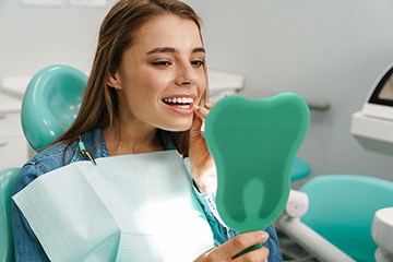 a patient admiring her smile 