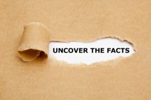 paper ripped to reveal the words “Uncover the Truth” underneath