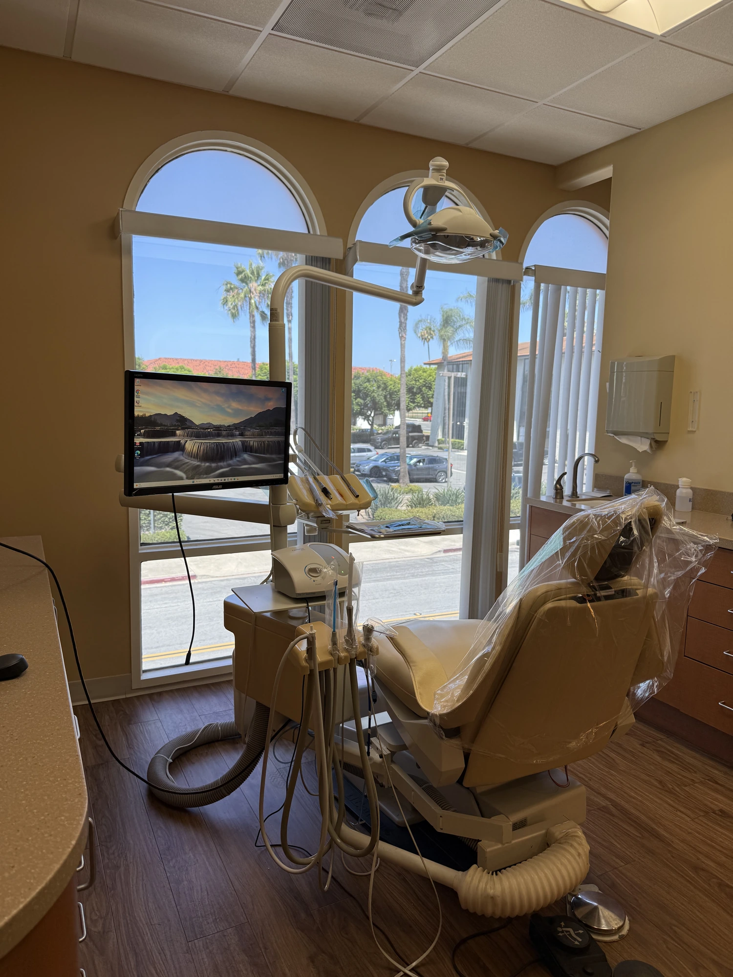 Dr. Zhang examining a patient's restored teeth
