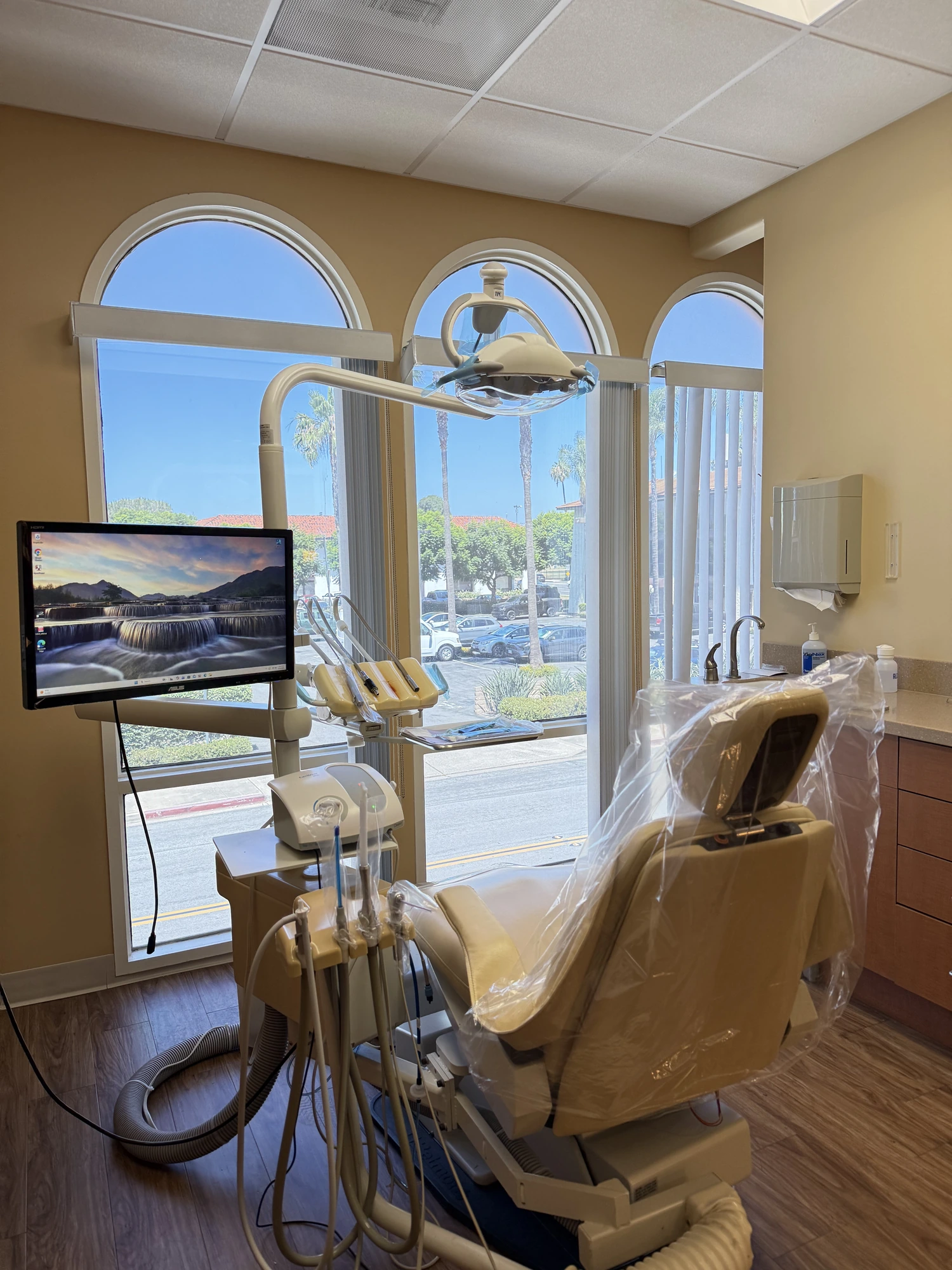 A Zhang Dental Group operatory with arched windows overlooking Tustin