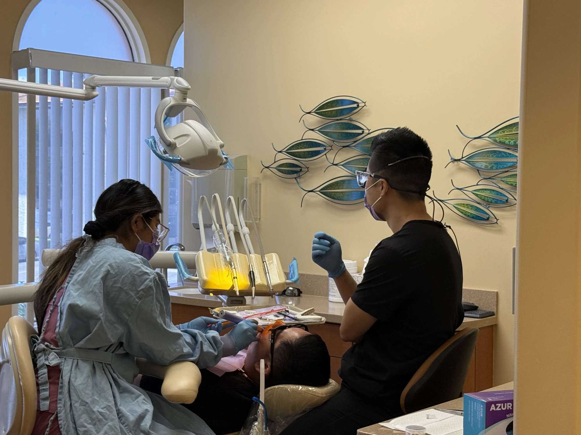 Dr. Zhang and an assistant treating a patient at Zhang Dental Group